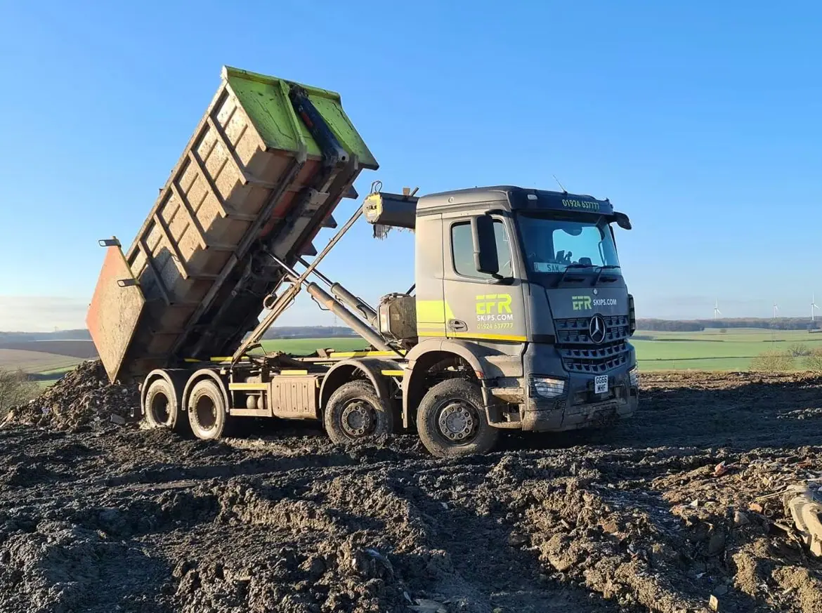 A tipper lorry working on open ground